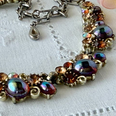 Vintage Lisner iridescent amber glass and topaz rhinestone link necklace with adjustable hook clasp, shown on display and close‑up to highlight its craftsmanship and condition.
