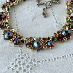 Vintage Lisner iridescent amber glass and topaz rhinestone link necklace with adjustable hook clasp, shown on display and close‑up to highlight its craftsmanship and condition.