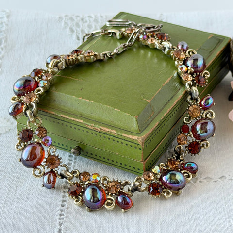 Vintage Lisner iridescent amber glass and topaz rhinestone link necklace with adjustable hook clasp, shown on display and close‑up to highlight its craftsmanship and condition.