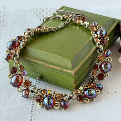 Vintage Lisner iridescent amber glass and topaz rhinestone link necklace with adjustable hook clasp, shown on display and close‑up to highlight its craftsmanship and condition.