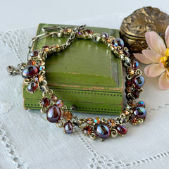 Vintage Lisner iridescent amber glass and topaz rhinestone link necklace with adjustable hook clasp, shown on display and close‑up to highlight its craftsmanship and condition.