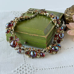 Vintage Lisner iridescent amber glass and topaz rhinestone link necklace with adjustable hook clasp, shown on display and close‑up to highlight its craftsmanship and condition.