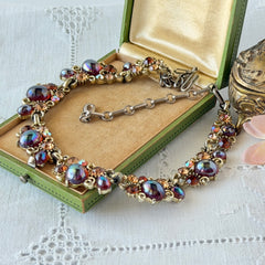 Vintage Lisner iridescent amber glass and topaz rhinestone link necklace with adjustable hook clasp, shown on display and close‑up to highlight its craftsmanship and condition.