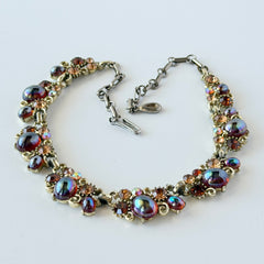 Vintage Lisner iridescent amber glass and topaz rhinestone link necklace with adjustable hook clasp, shown on display and close‑up to highlight its craftsmanship and condition.