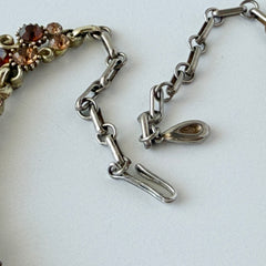 Vintage Lisner iridescent amber glass and topaz rhinestone link necklace with adjustable hook clasp, shown on display and close‑up to highlight its craftsmanship and condition.