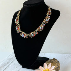 Vintage Lisner iridescent amber glass and topaz rhinestone link necklace with adjustable hook clasp, shown on display and close‑up to highlight its craftsmanship and condition.