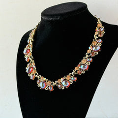 Vintage Lisner iridescent amber glass and topaz rhinestone link necklace with adjustable hook clasp, shown on display and close‑up to highlight its craftsmanship and condition.