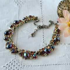 Vintage Lisner iridescent amber glass and topaz rhinestone link necklace with adjustable hook clasp, shown on display and close‑up to highlight its craftsmanship and condition.