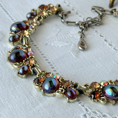 Vintage Lisner iridescent amber glass and topaz rhinestone link necklace with adjustable hook clasp, shown on display and close‑up to highlight its craftsmanship and condition.