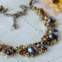 Vintage Lisner iridescent amber glass and topaz rhinestone link necklace with adjustable hook clasp, shown on display and close‑up to highlight its craftsmanship and condition.