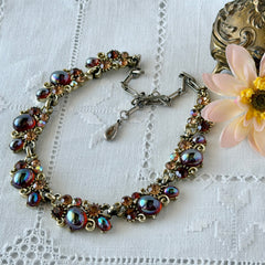 Vintage Lisner iridescent amber glass and topaz rhinestone link necklace with adjustable hook clasp, shown on display and close‑up to highlight its craftsmanship and condition.