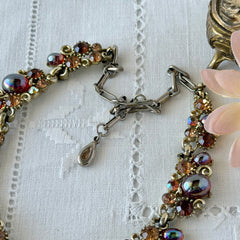 Vintage Lisner iridescent amber glass and topaz rhinestone link necklace with adjustable hook clasp, shown on display and close‑up to highlight its craftsmanship and condition.