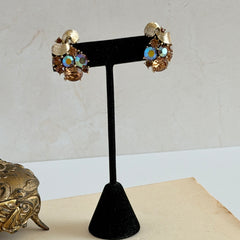 Vintage Lisner light smoked topaz and AB topaz gold‑tone floral clip‑on earrings from the 1950s.