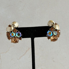 Vintage Lisner light smoked topaz and AB topaz gold‑tone floral clip‑on earrings from the 1950s.