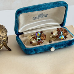 Vintage Lisner light smoked topaz and AB topaz gold‑tone floral clip‑on earrings from the 1950s.