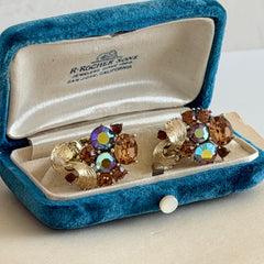 Vintage Lisner light smoked topaz and AB topaz gold‑tone floral clip‑on earrings from the 1950s.