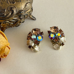 Vintage Lisner light smoked topaz and AB topaz gold‑tone floral clip‑on earrings from the 1950s.