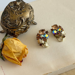 Vintage Lisner light smoked topaz and AB topaz gold‑tone floral clip‑on earrings from the 1950s.