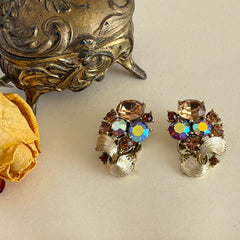 Vintage Lisner light smoked topaz and AB topaz gold‑tone floral clip‑on earrings from the 1950s.