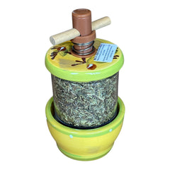 Hand-painted Provence herb mill with green, yellow, and brown olive branch motif on ceramic base, featuring a transparent chamber filled with dried herbs and topped with a wooden handle and cork stoppers.