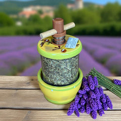 Hand-painted Provence herb mill with green, yellow, and brown olive branch motif on ceramic base, featuring a transparent chamber filled with dried herbs and topped with a wooden handle and cork stoppers.