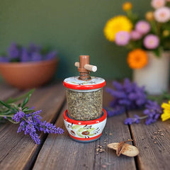 Vintage Provence herb mill with hand-painted olive branch motif in green and black on a cream ceramic base, featuring a ridged interior and terracotta accents.