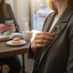 Vintage MMA Fabergé replica Christmas wreath brooch with green guilloché enamel leaves, red berry accents, clear rhinestone ribbon details, and gold‑plated finish; signed MMA © FBS, excellent condition