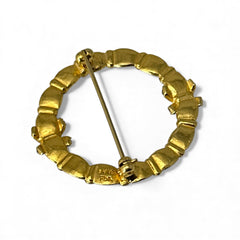 Vintage MMA Fabergé replica Christmas wreath brooch with green guilloché enamel leaves, red berry accents, clear rhinestone ribbon details, and gold‑plated finish; signed MMA © FBS, excellent condition