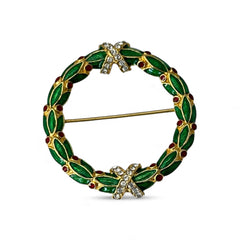 Vintage MMA Fabergé replica Christmas wreath brooch with green guilloché enamel leaves, red berry accents, clear rhinestone ribbon details, and gold‑plated finish; signed MMA © FBS, excellent condition