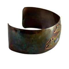 Vintage Southwestern copper and brass cuff bracelet with abalone wolf motif and natural patina, shown from multiple angles.