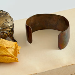 Vintage Southwestern copper and brass cuff bracelet with abalone wolf motif and natural patina, shown from multiple angles.