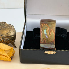 Vintage Southwestern copper and brass cuff bracelet with abalone wolf motif and natural patina, shown from multiple angles.