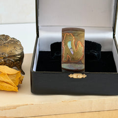 Vintage Southwestern copper and brass cuff bracelet with abalone wolf motif and natural patina, shown from multiple angles.