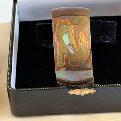 Vintage Southwestern copper and brass cuff bracelet with abalone wolf motif and natural patina, shown from multiple angles.