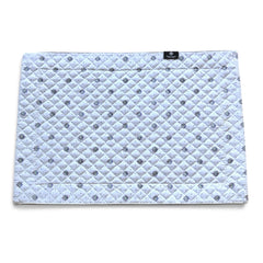 Reversible quilted cotton placemat in Lauris Light Green by Marat d’Avignon, featuring a white center with lavender purple floral medallions and a border of lavender sprigs and olive branches, with a white reverse side  scattered with tiny lavender  blossoms, crafted in Provence.