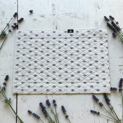 Quilted cotton placemat in light blue and white with Provençal floral and paisley motifs, handcrafted in France by Tissus Toselli.