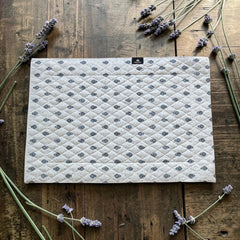 Quilted cotton placemat in light blue and white with Provençal floral and paisley motifs, handcrafted in France by Tissus Toselli.