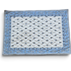 Quilted cotton placemat in light blue and white with Provençal floral and paisley motifs, handcrafted in France by Tissus Toselli.