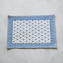 Quilted cotton placemat in light blue and white with Provençal floral and paisley motifs, handcrafted in France by Tissus Toselli.