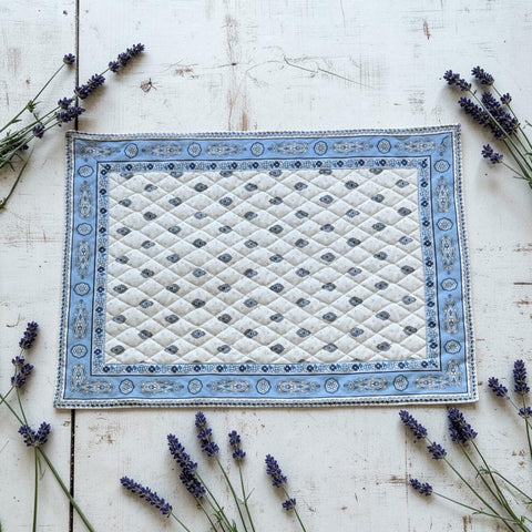 Quilted cotton placemat in light blue and white with Provençal floral and paisley motifs, handcrafted in France by Tissus Toselli.