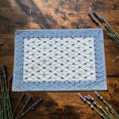 Quilted cotton placemat in light blue and white with Provençal floral and paisley motifs, handcrafted in France by Tissus Toselli.