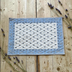 Quilted cotton placemat in light blue and white with Provençal floral and paisley motifs, handcrafted in France by Tissus Toselli.