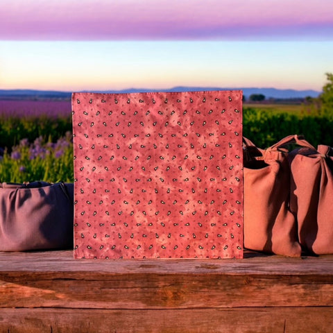 Provence cotton napkins featuring a rust orange background with red and yellow floral designs from Marat d’Avignon Tradition Collection, made of 100% cotton, measuring 18" x 18", with vibrant, fade-resistant prints. Made in France.