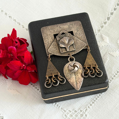 Vintage Marjorie Baer MB SF modernist brooch in textured silver tone and brass with stylized ginkgo leaf and dangling elements, shown from multiple angles to highlight design and condition.