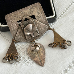 Vintage Marjorie Baer MB SF modernist brooch in textured silver tone and brass with stylized ginkgo leaf and dangling elements, shown from multiple angles to highlight design and condition.