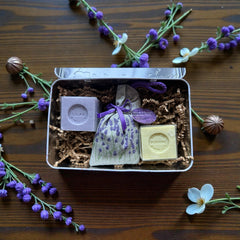 French holiday tin gift box with two mini Marseille soaps and a lavender sachet nestled in crinkle paper, available in Paris, Nice, or Côte d’Azur designs — a festive surprise gift from France.