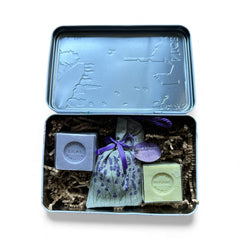 French holiday tin gift box with two mini Marseille soaps and a lavender sachet nestled in crinkle paper, available in Paris, Nice, or Côte d’Azur designs — a festive surprise gift from France.