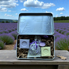 French holiday tin gift box with two mini Marseille soaps and a lavender sachet nestled in crinkle paper, available in Paris, Nice, or Côte d’Azur designs — a festive surprise gift from France.
