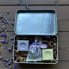 French holiday tin gift box with two mini Marseille soaps and a lavender sachet nestled in crinkle paper, available in Paris, Nice, or Côte d’Azur designs — a festive surprise gift from France.