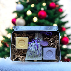 French holiday tin gift box with two mini Marseille soaps and a lavender sachet nestled in crinkle paper, available in Paris, Nice, or Côte d’Azur designs — a festive surprise gift from France.
